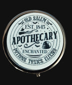 Round pill tin with 'Old Salem Apothecary' text on a wooden background