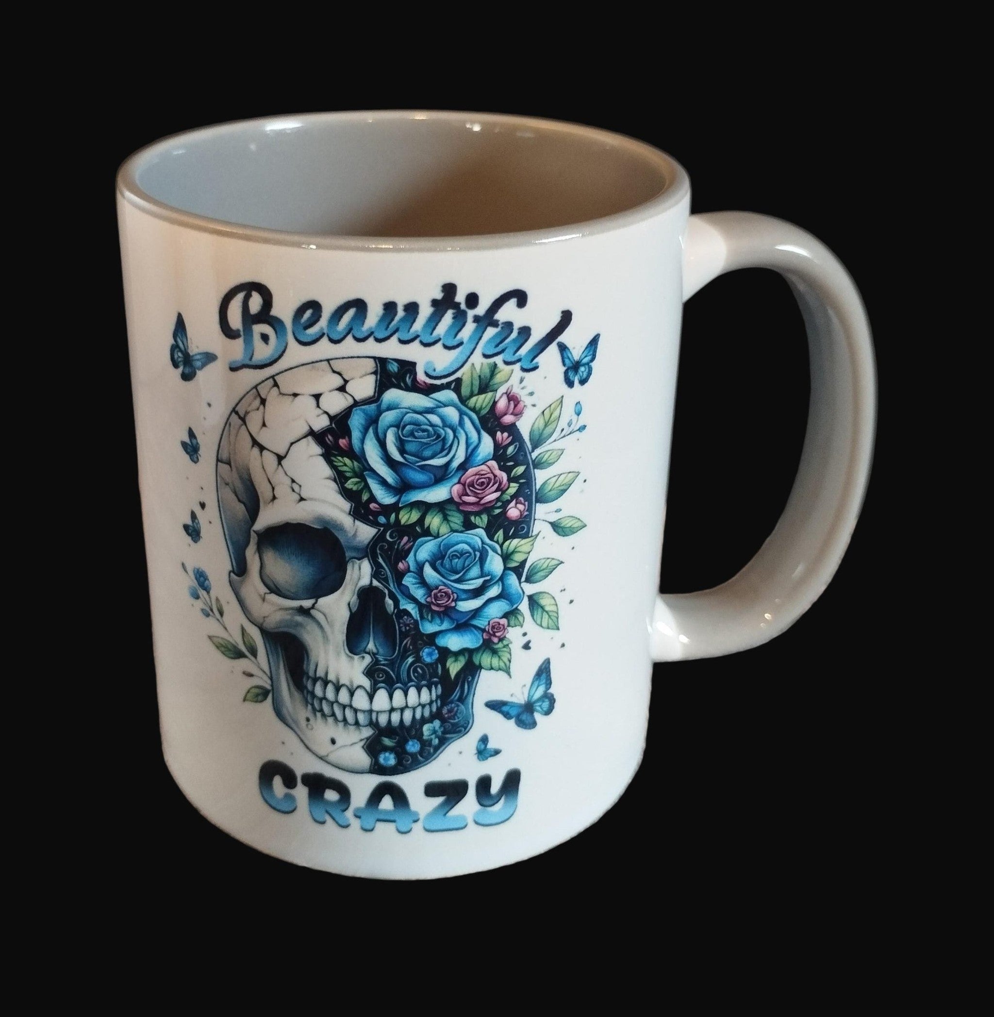 Mug with skull and floral design on a wooden surface