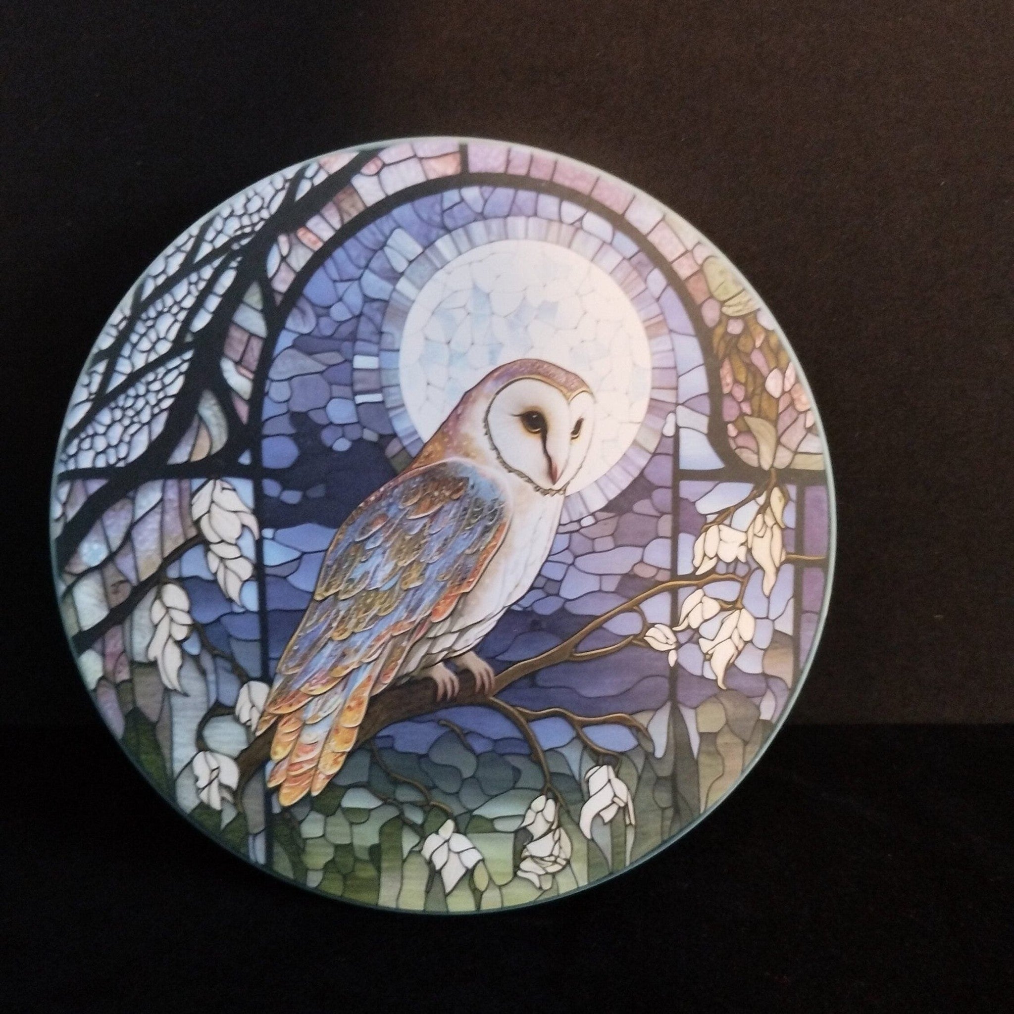 Stained glass-style coaster with an owl design on a dark background