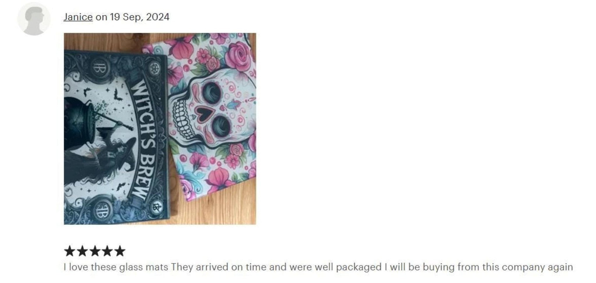Two glass mats with skull designs on a wooden surface, reviewed by Janica.