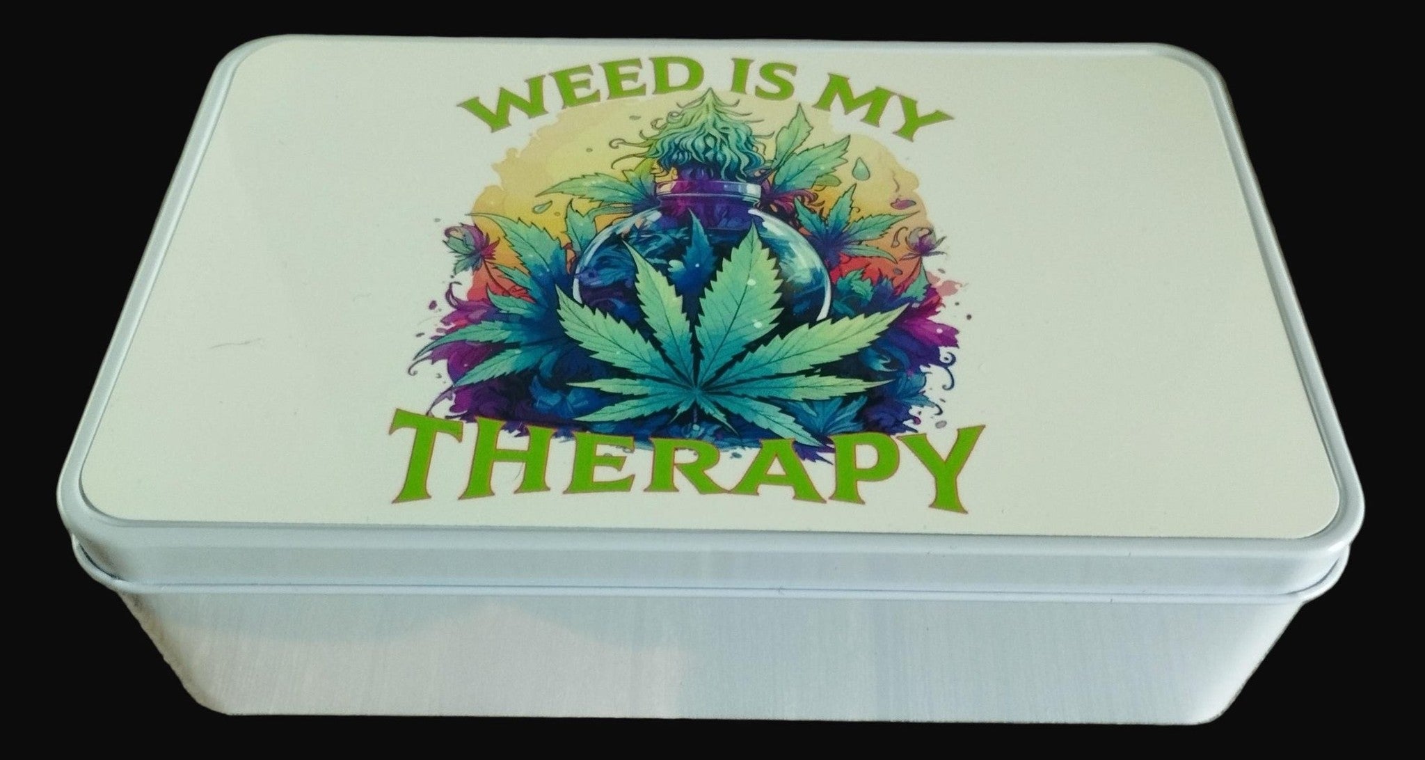 White box with colorful cannabis leaf design and 'Weed is my Therapy' text on a wooden surface.