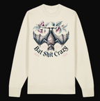 Beige long-sleeve shirt with a bat and floral design and text on a white background