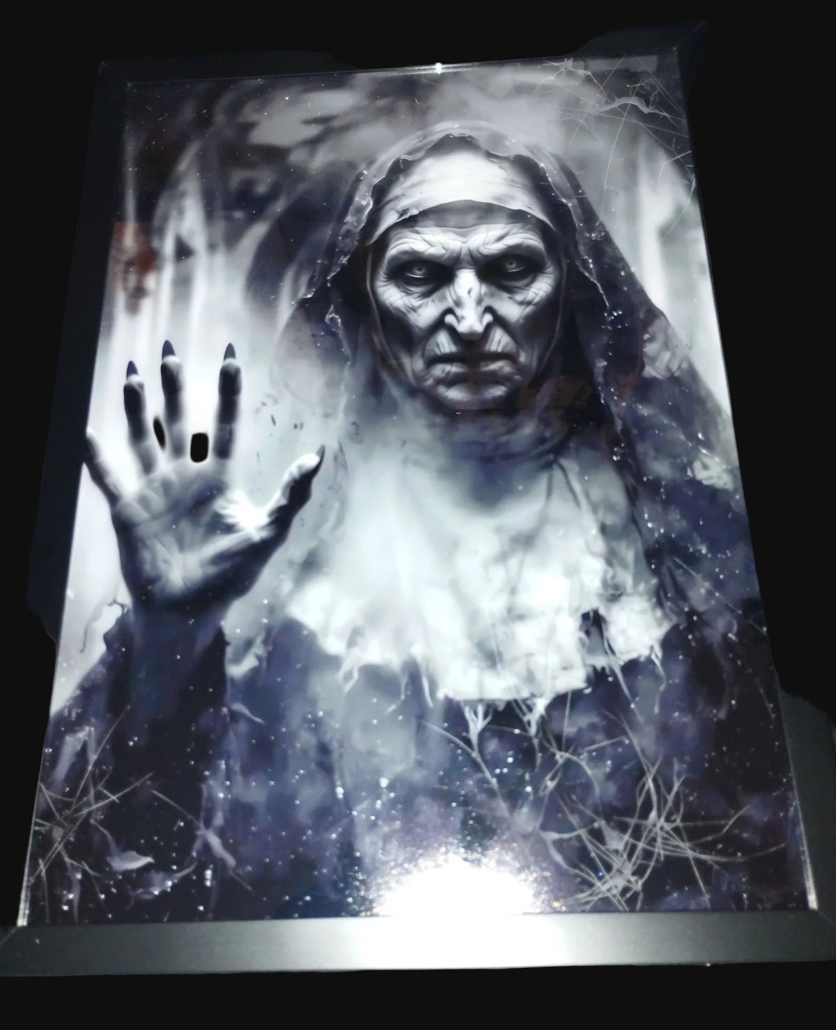 Creepy nun gothic art print displayed in a black frame, with a raised hand, ghostly mist and cobwebs