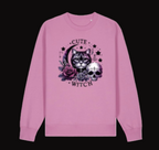 Pink sweatshirt with a cat and skull design and 'Cute Witch' text on a white background