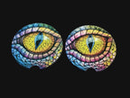 Colorful eye designs on a wooden surface