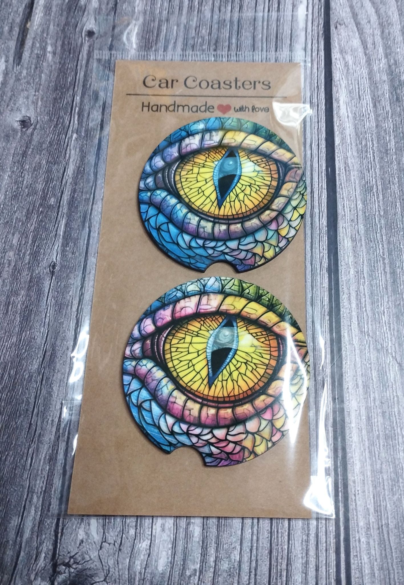 Packaged colorful eye design coasters on a wooden surface