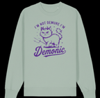 Green sweatshirt with purple graphic and text 'I'm not demure I'm demonic' on a black background