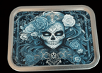 Decorative tobacco tin with a skull and floral design on a black background