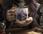 Person holding a mug with a skull and floral design, surrounded by mystical items.