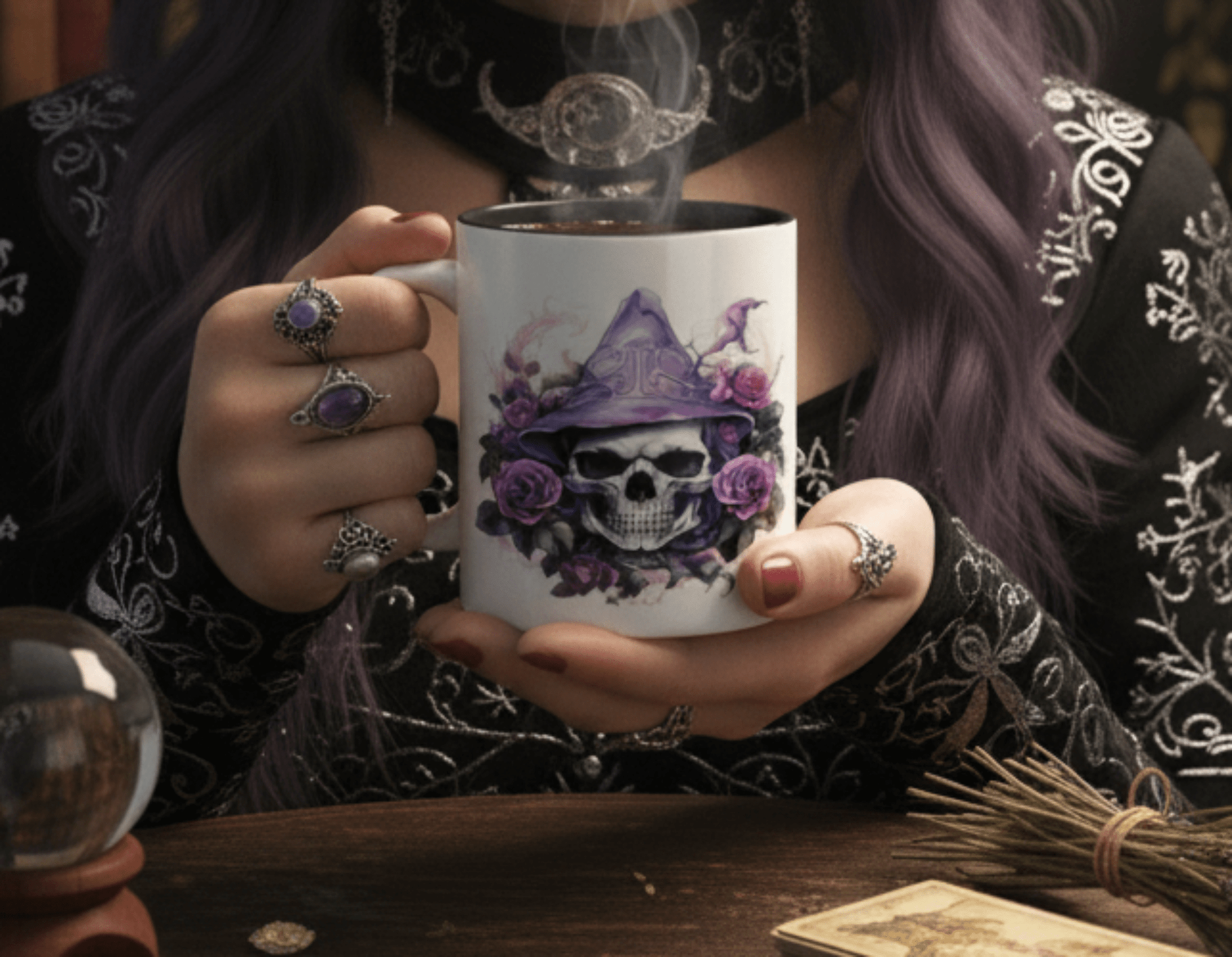 Person holding a mug with a skull and floral design, surrounded by mystical items.