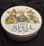 Round tin featuring Halloween Highland cows and the words I Put a Spell on You