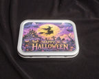 Angled view of a Happy Halloween tobacco and trinket tin with colourful witch and pumpkin artwork