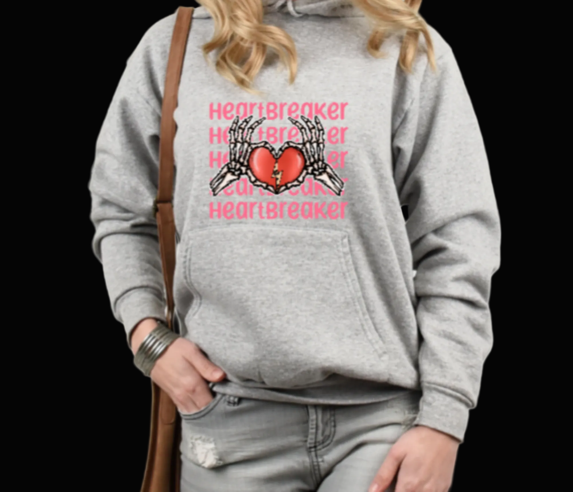 Person wearing a gray hoodie with a graphic design and text on a plain background