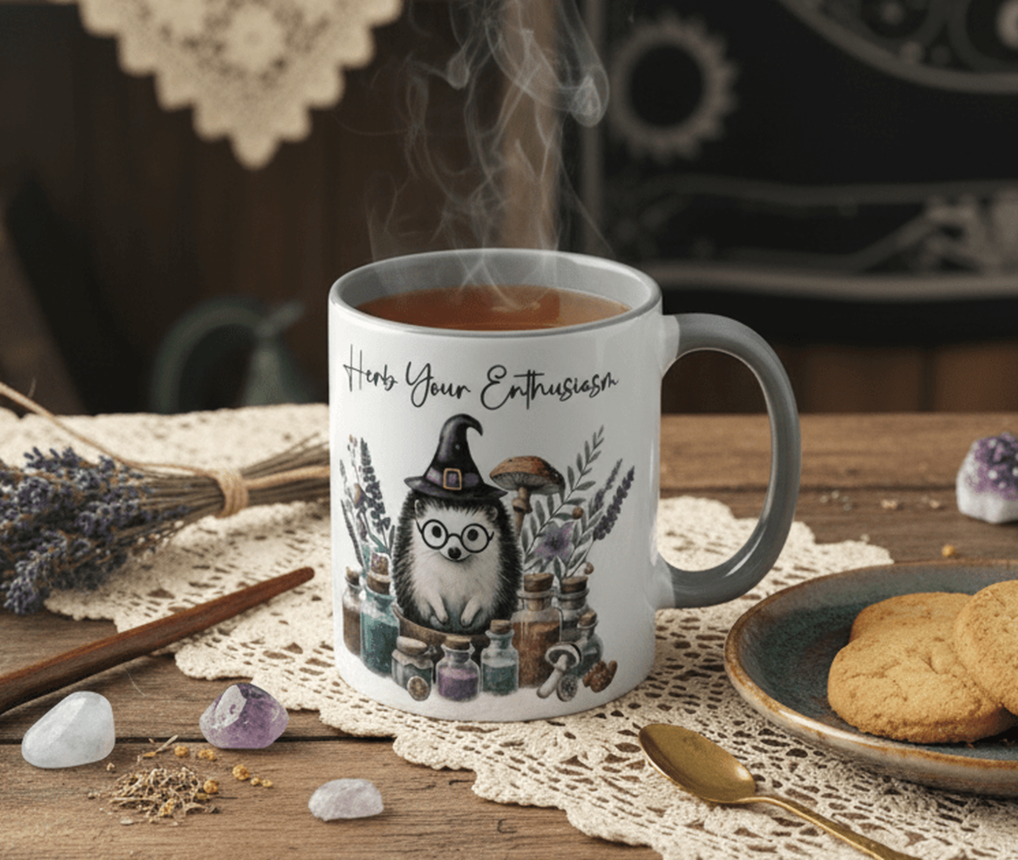 Mug with a hedgehog in a witch hat surrounded by herbs and potions, steaming hot beverage inside, on a table with cookies and lavender.