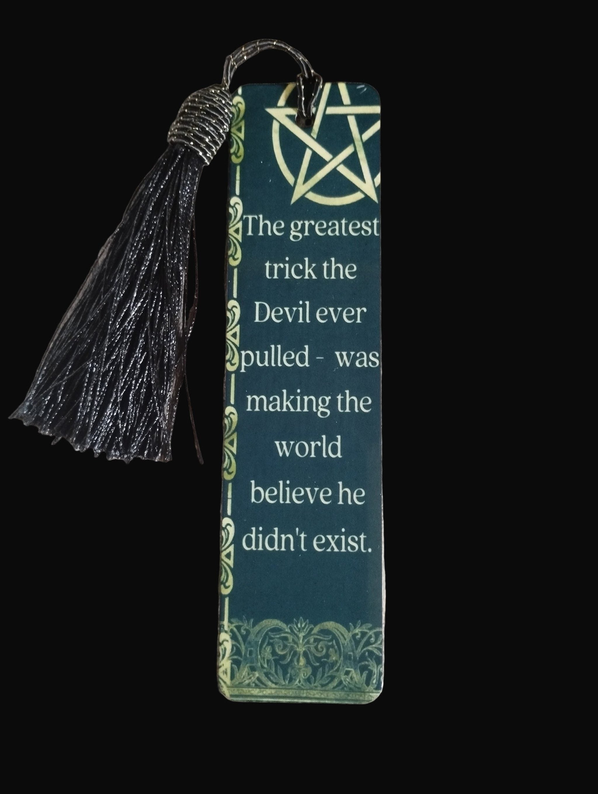 Bookmark with tassel and quote on a wooden surface
