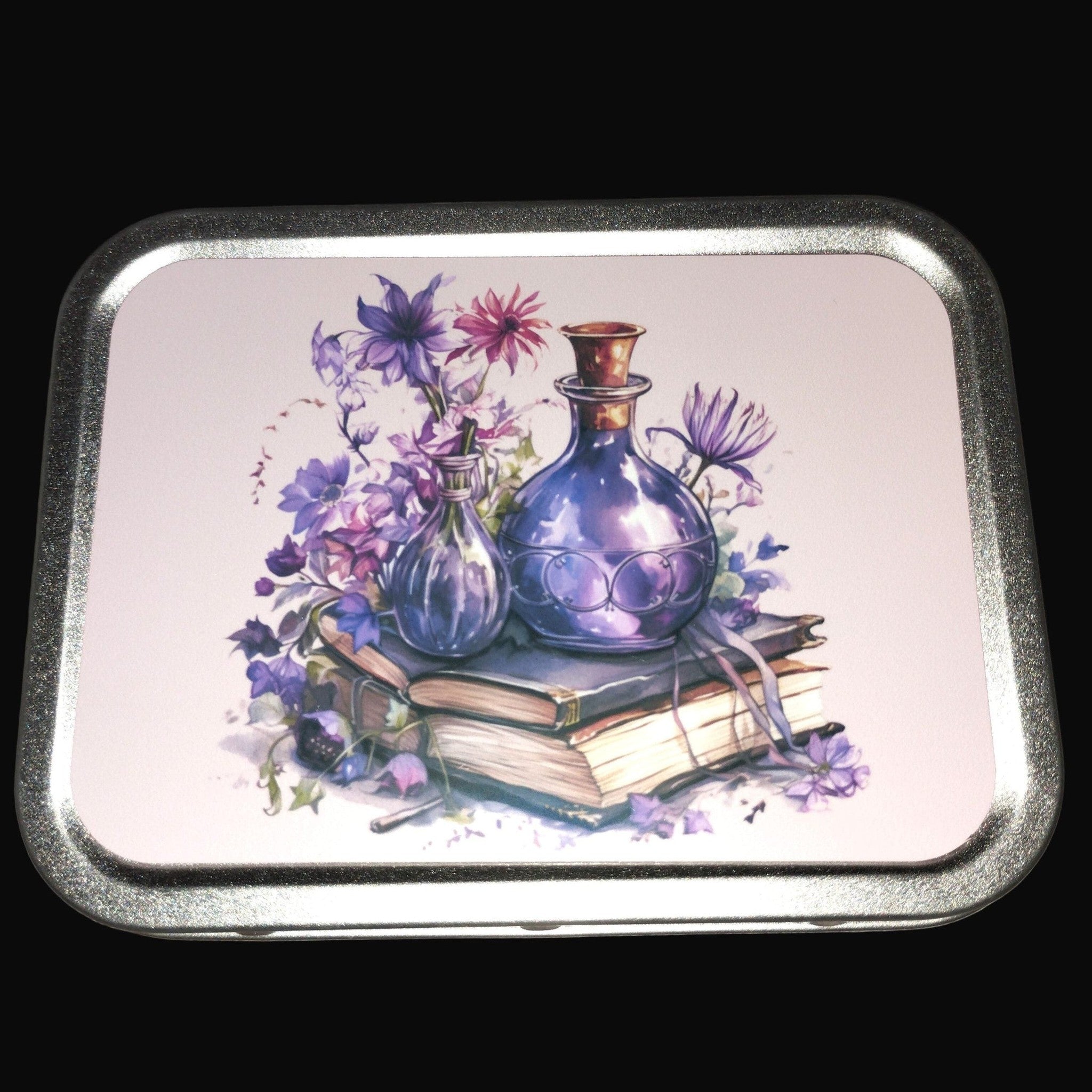 small metal tin with a potions and book design. purple and pinks