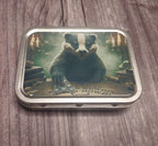 Small metal trinket tin featuring a badger seated at a Ouija board by candlelight