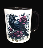 Mug with a black crow and pink roses design on a white background