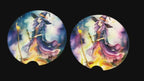 Two circular coasters with witch designs on a wooden surface