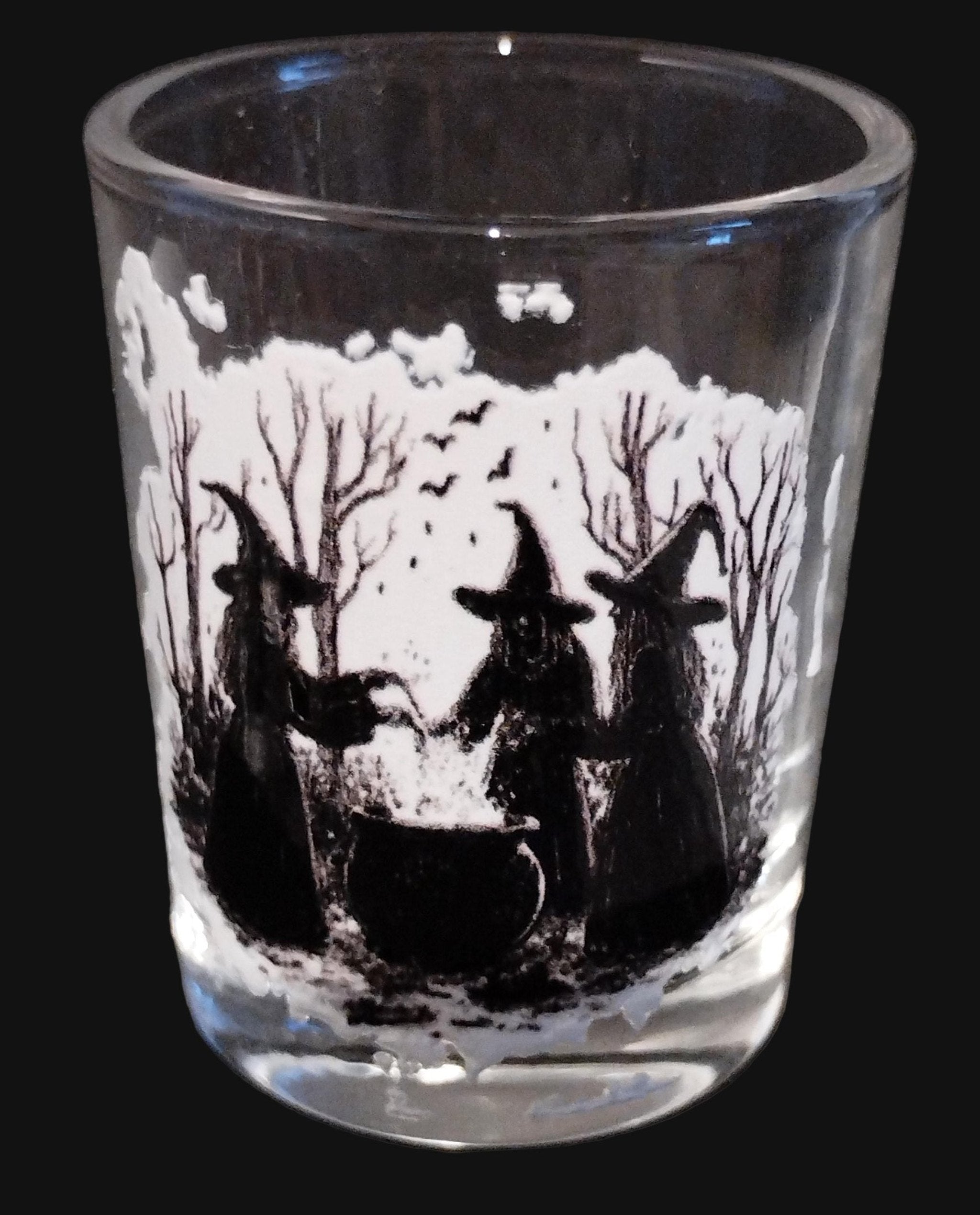 Clear glass  design of three witchs around a cauldron on a dark background