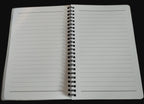 Open notebook with lined pages on a wooden surface