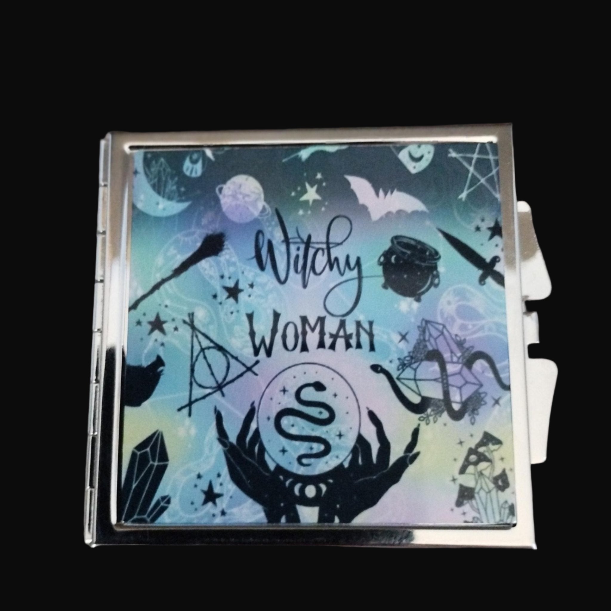 Cigarette case with 'Witchy Woman' design on a wooden surface