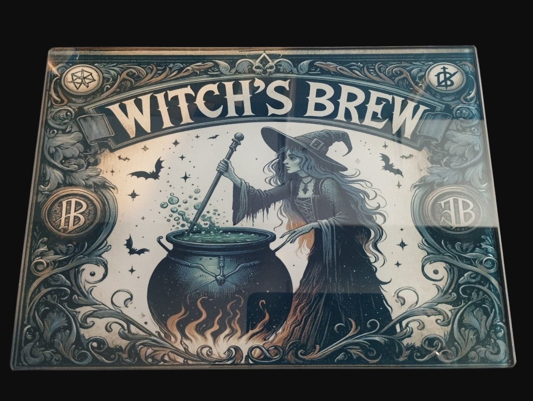 Decorative sign with a witch and cauldron, labeled 'Witch's Brew', on a dark background.