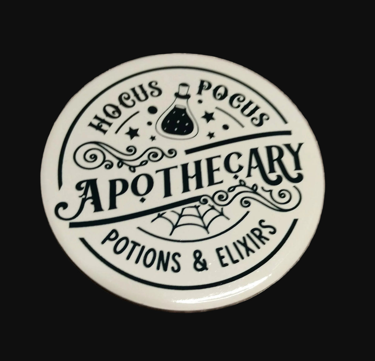 Hocus Pocus Apothecary round ceramic coaster with potion bottle and spider web design