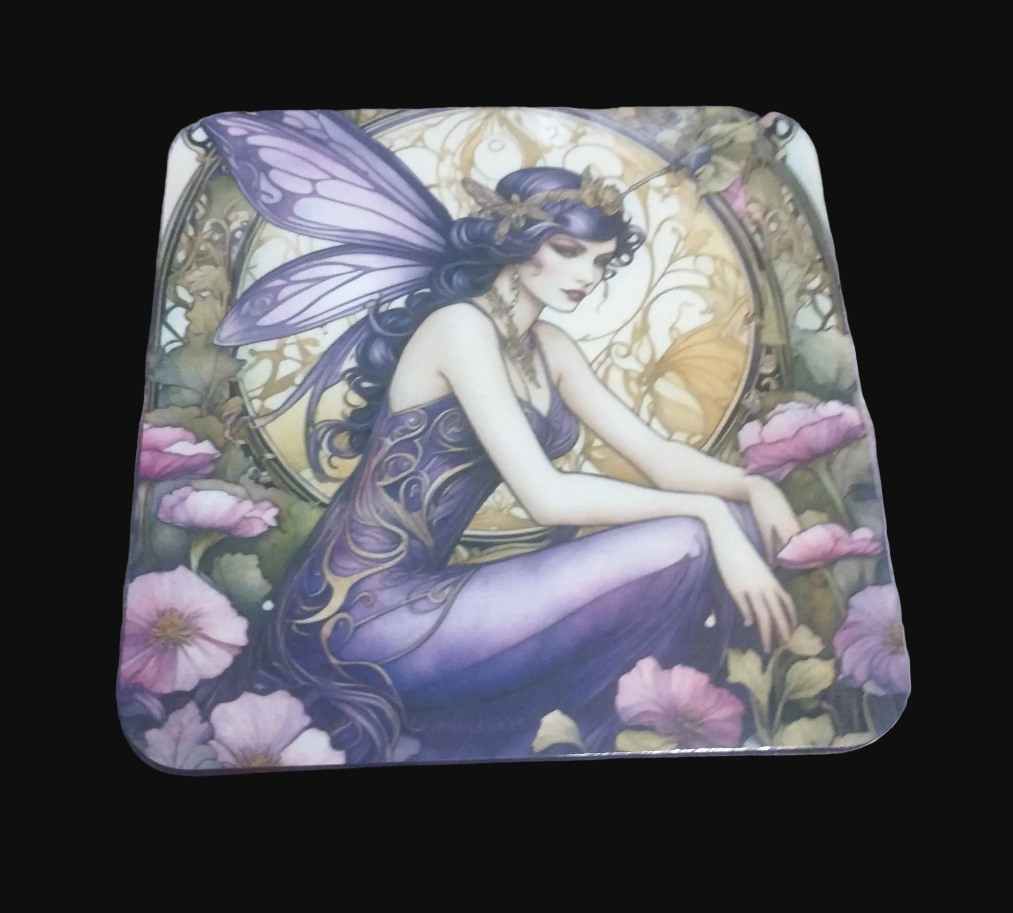 Coaster with fairy design on a wooden surface