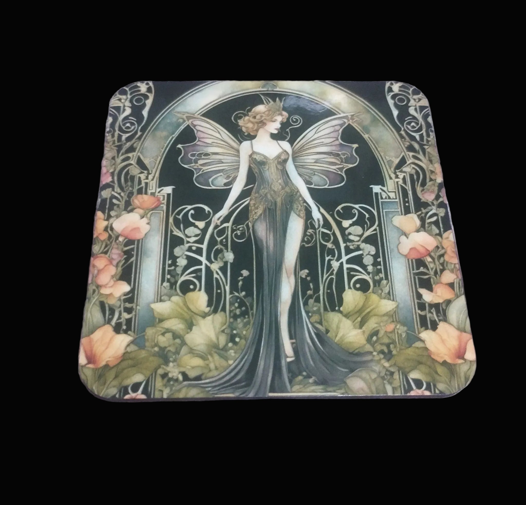 Coaster with fairy design on a wooden surface