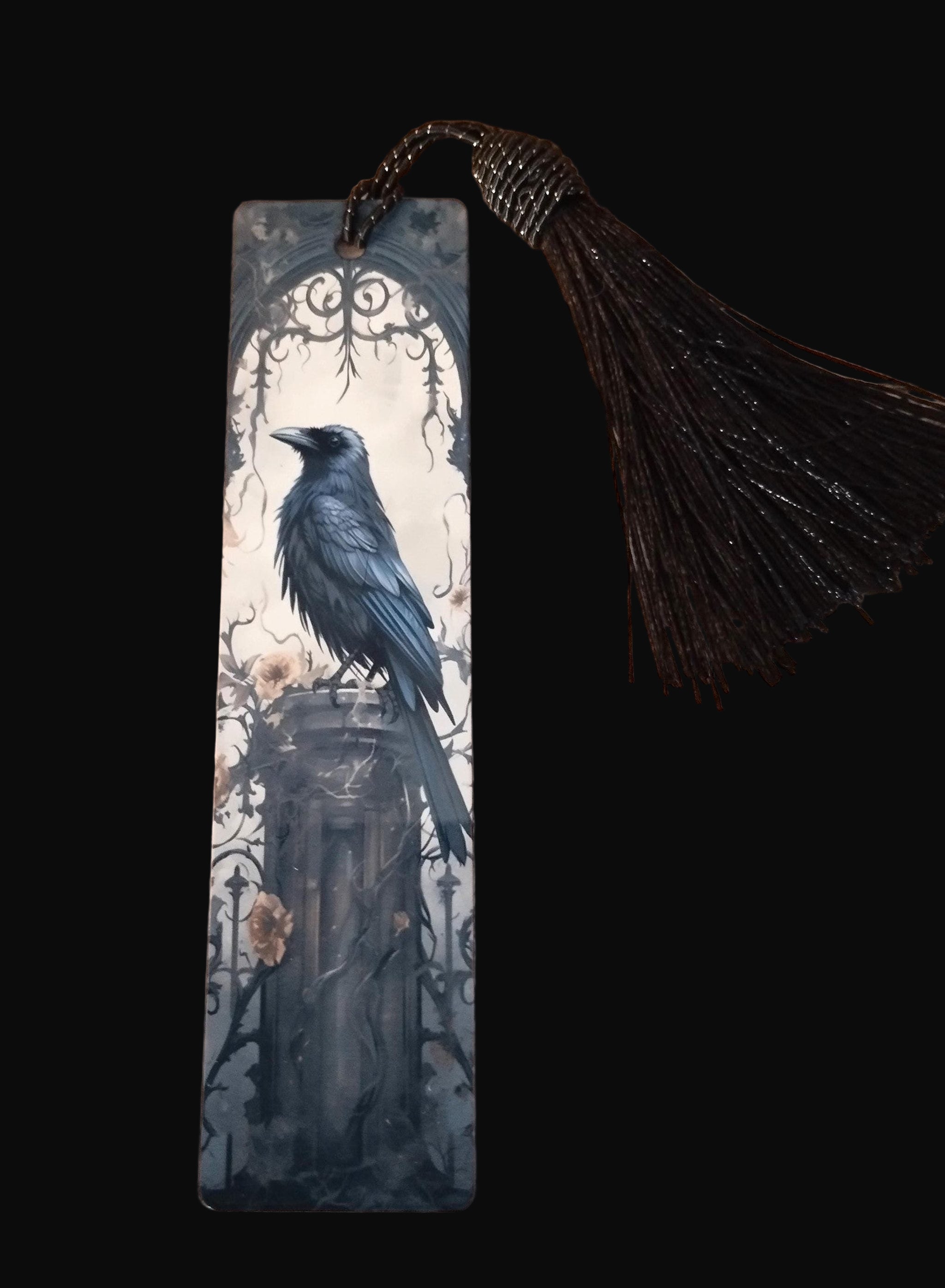 Bookmark with a crow design on a wooden surface
