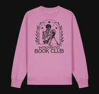 Pink sweatshirt with skeleton and book design labeled 'Introverted Book Club' on a white background