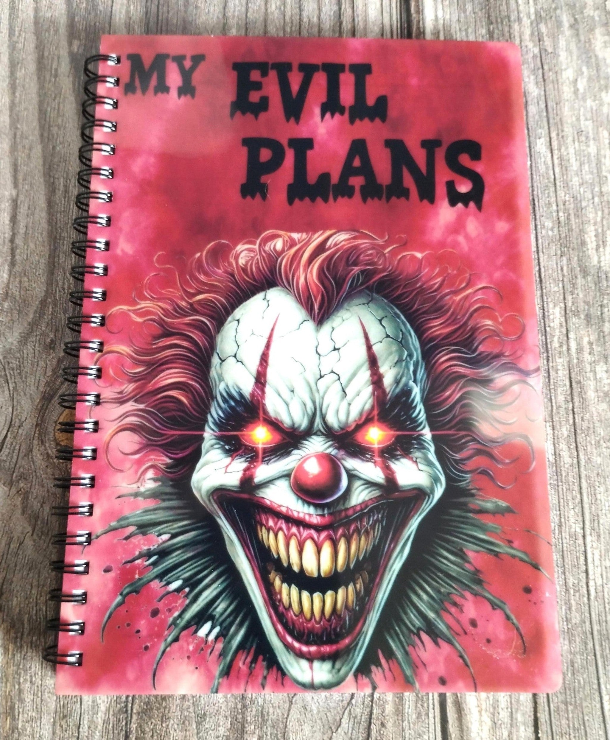 Notebook with a clown design and 'My Evil Plans' text on a red background