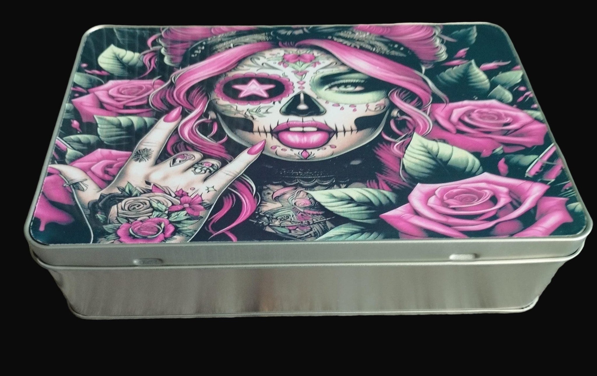 Metal tin with a colorful design of a skull and roses on a wooden surface