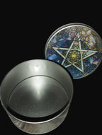Metallic container with a decorative lid featuring a star design on a wooden surface.