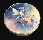 Round metal storage tin featuring a beautiful celestial watercolour fairy design in shades of blue, lilac and gold