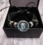 Horror clown bracelet on wooden surface