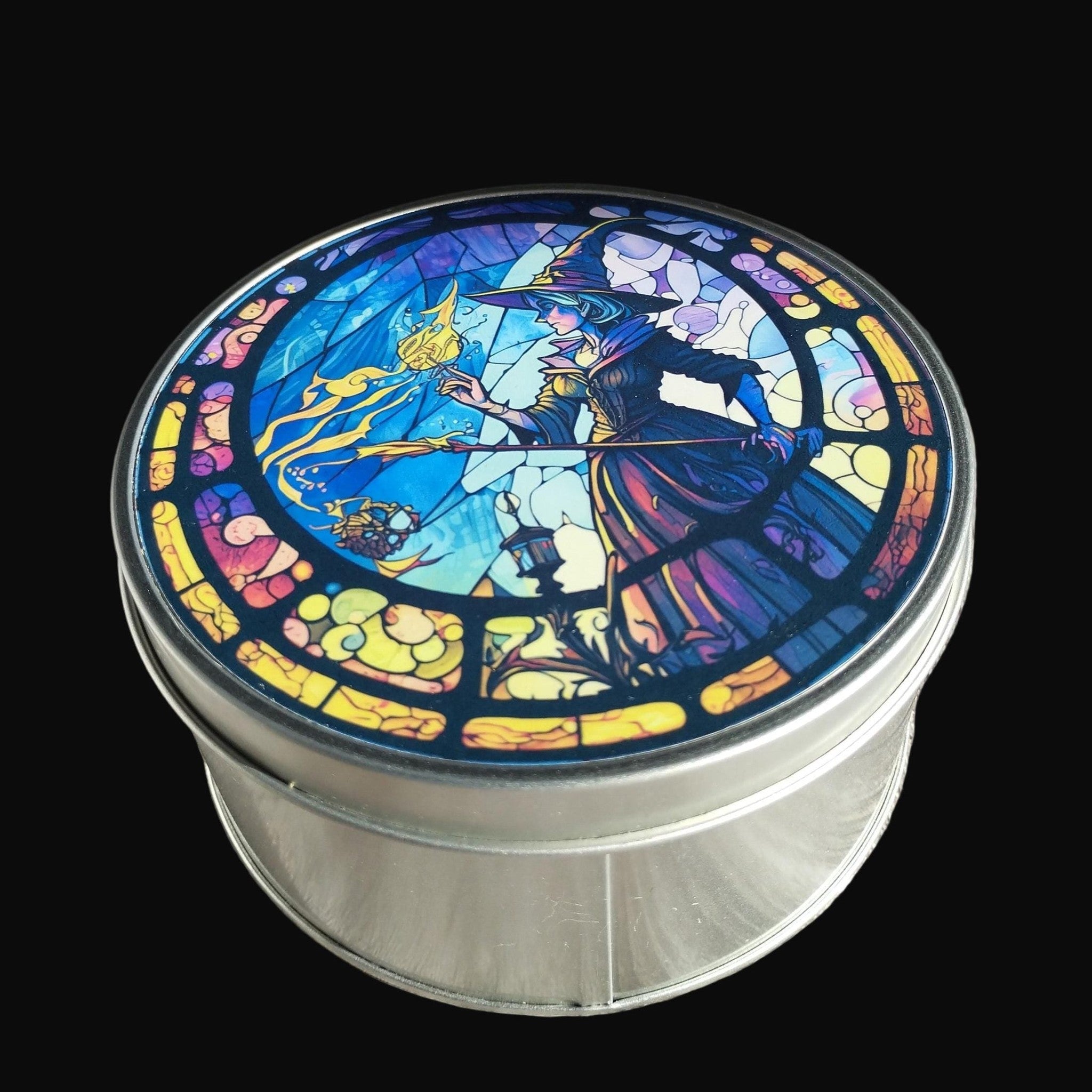 Decorative tin with stained glass-style artwork on a wooden surface