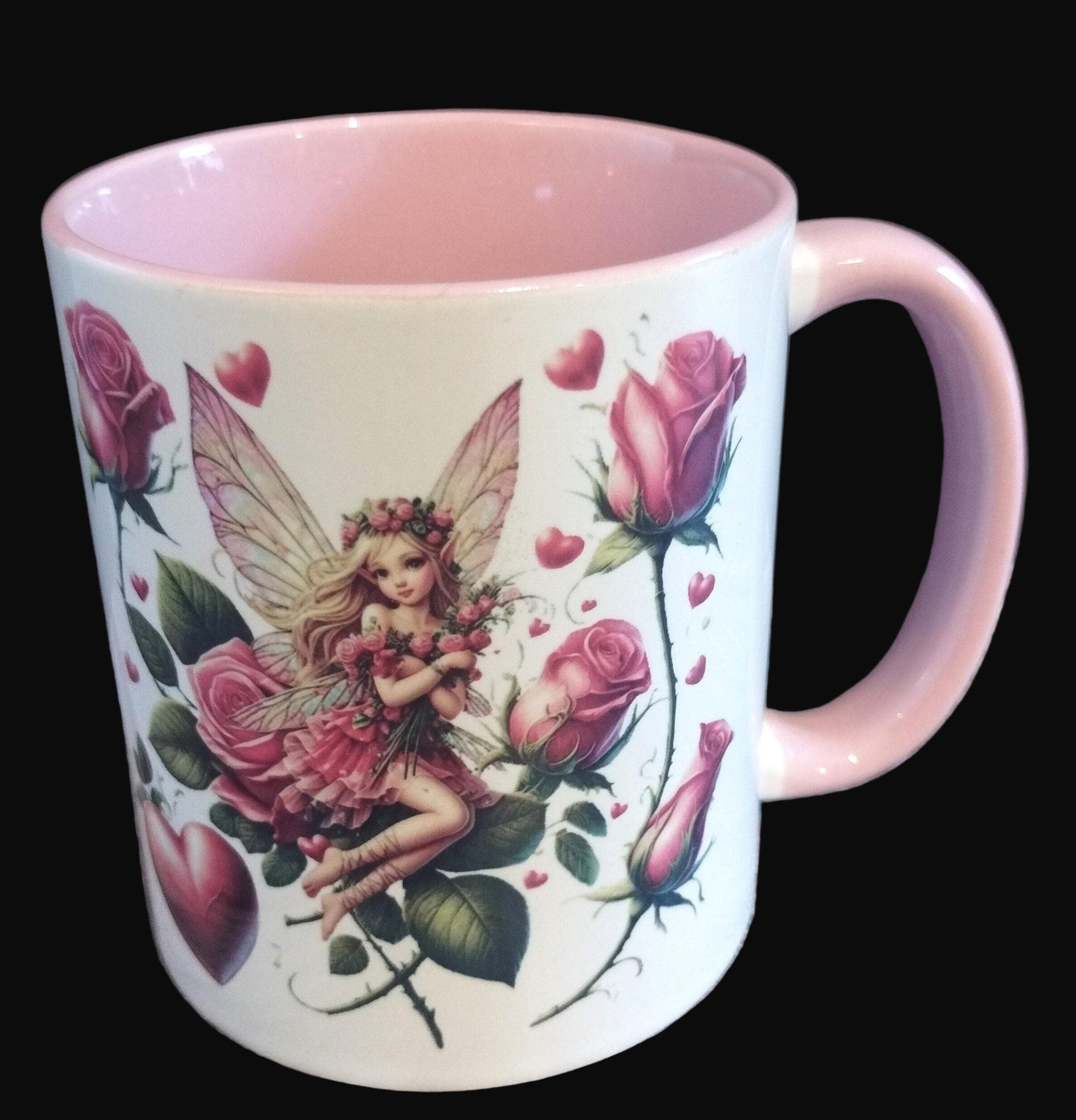 Mug with fairy and floral design on a wooden surface
