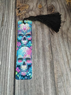Colorful skull design bookmark with tassel on a wooden surface