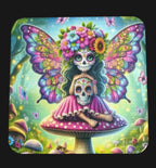 Colorful artwork of a sugar skull fairy with butterfly wings on a mushroom, set against a wooden background.