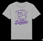 Gray t-shirt with purple graphic and text 'I'm not demure, I'm demonic' on a black background