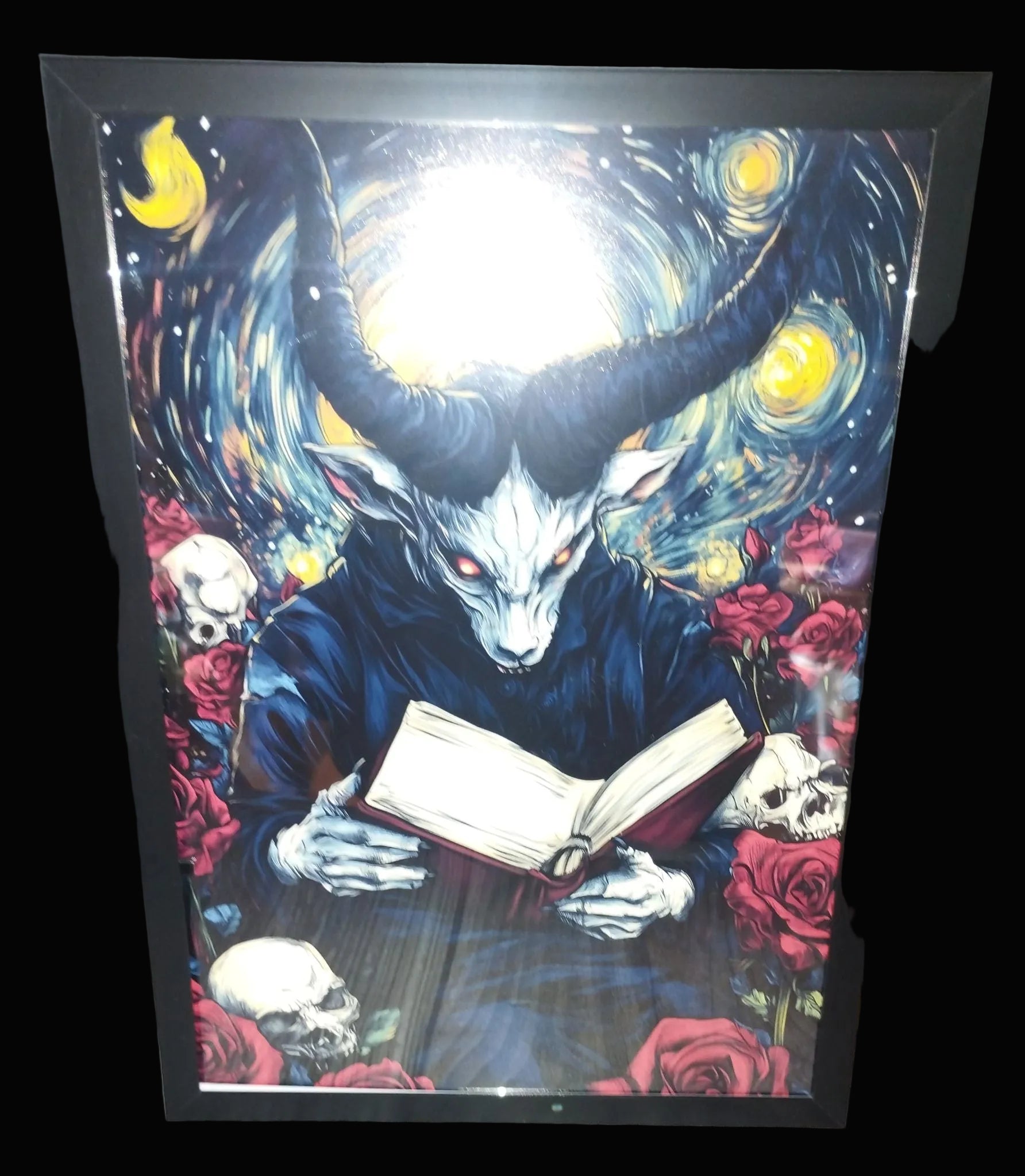 Framed artwork of a creature with horns reading a book against a starry night sky.