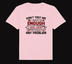 Pink t-shirt with text 'Don't test me. I watch enough crime shows to solve any problem.' on a white background