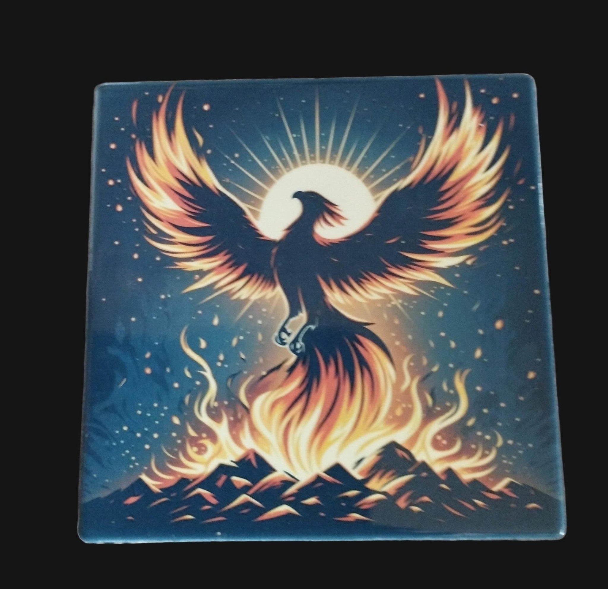 Phoenix bird rising from flames on a blue background with mountains, on a wooden surface.