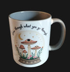 Mug with mushroom design and motivational quote on a wooden surface