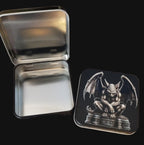 Metallic tin with a gargoyle design on a black surface