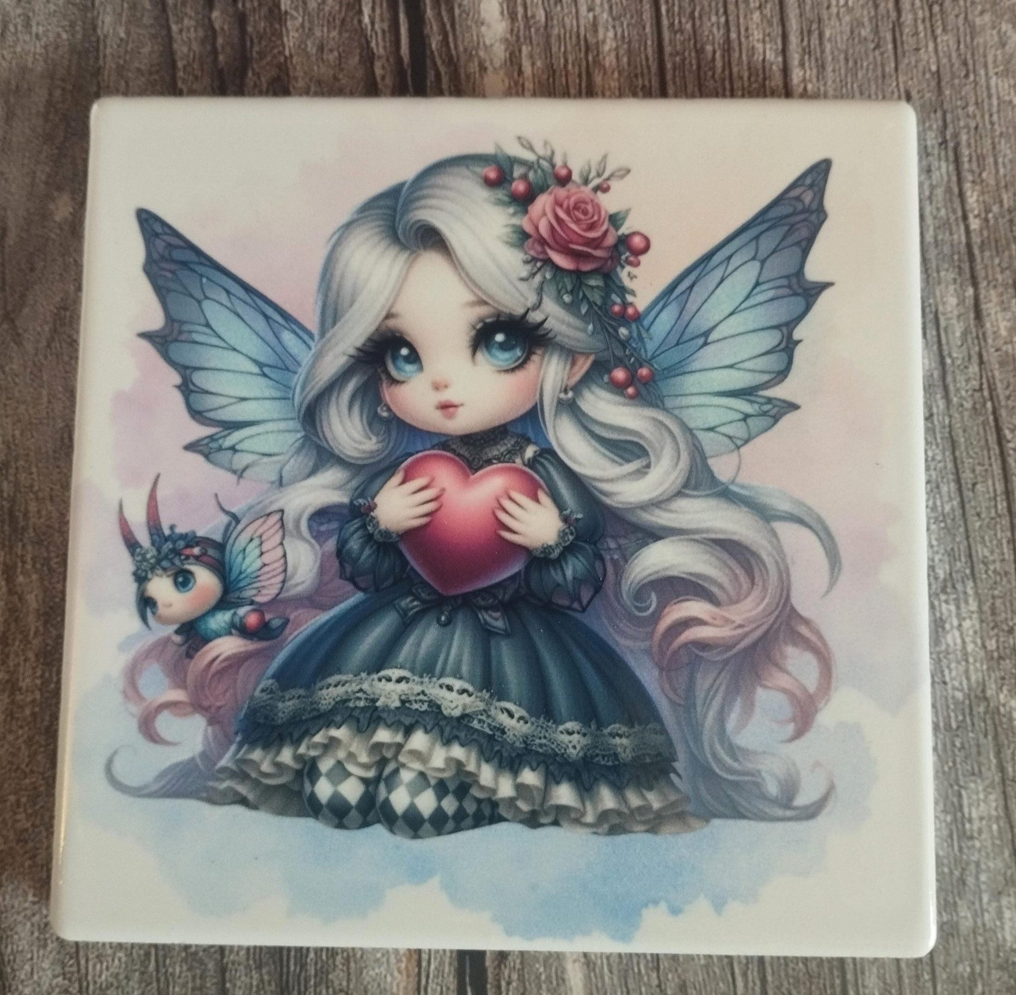 Illustration of a fairy holding a heart on a wooden surface