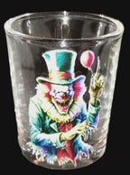 Glass with a colorful clown design on a dark surface
