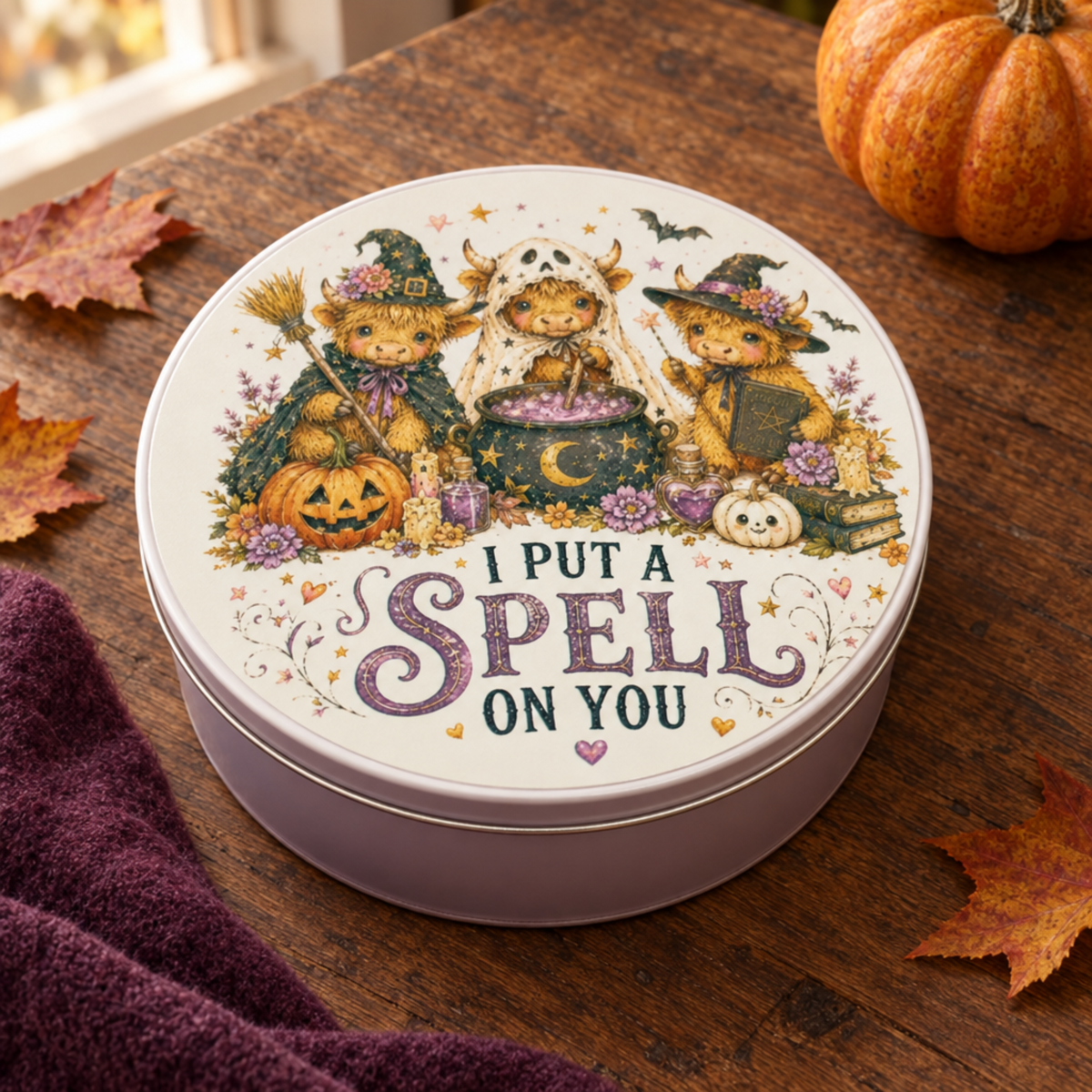 Halloween Highland cow tin in a cosy autumn setting